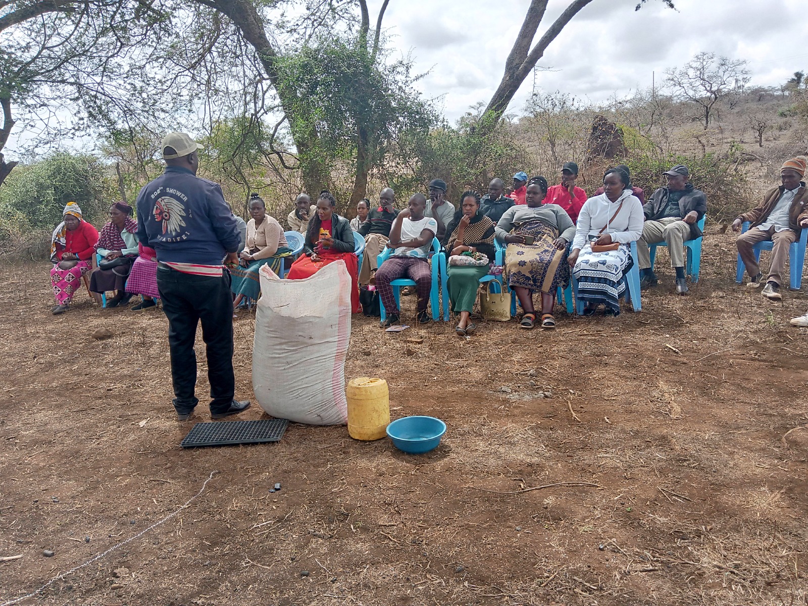 Outdoor farmer meeting with input demonstration